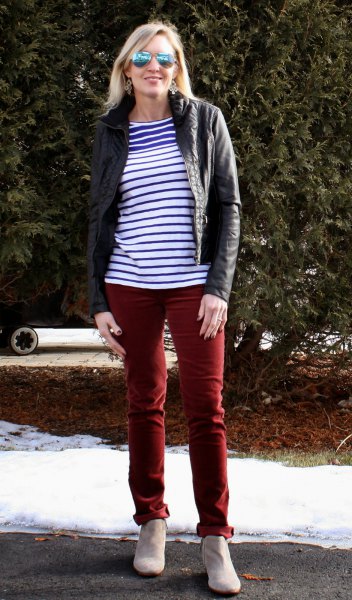 blue and white striped t-shirt with black motorcycle jacket and brown pants