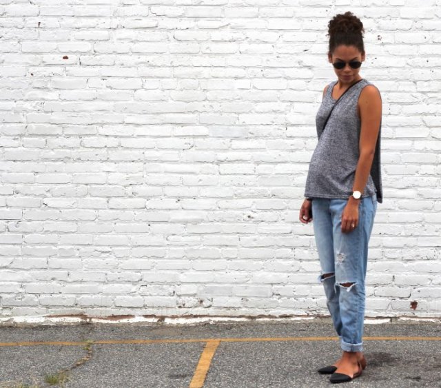 Gray sleeveless scoop neck relaxed fit sweater with light blue jeans