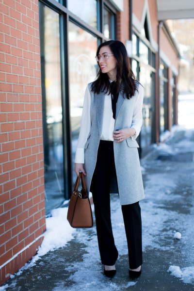 gray wool longline vest with white blouse and black straight leg chinos