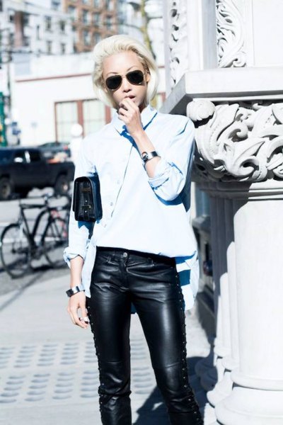 Light blue shirt with buttons and black leather trousers with lacing