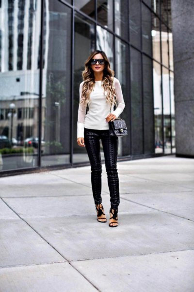 White, figure-hugging long-sleeved sweater with leather leggings and open heels