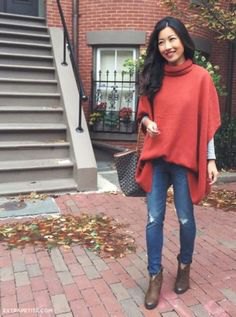 Green oversized poncho sweater with a high neck and sleeves