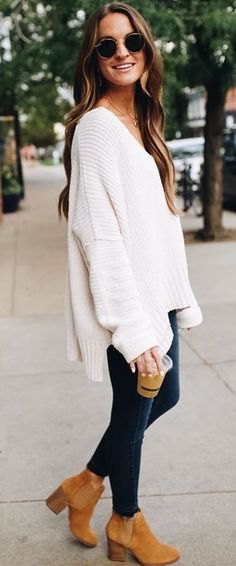 White V-neck oversized sweater and camel heel suede ankle boots