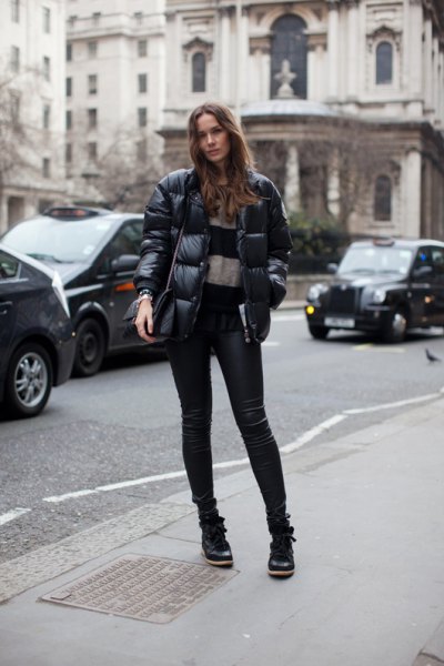 Puffer jacket with a wide striped sweater and leather pants
