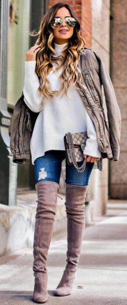 White chunky sweater with light gray oversized leather jacket and suede fall over-the-knee boots