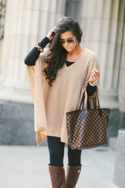 Ivory ribbed cape sweater with black leggings and gray over the knee fall boots