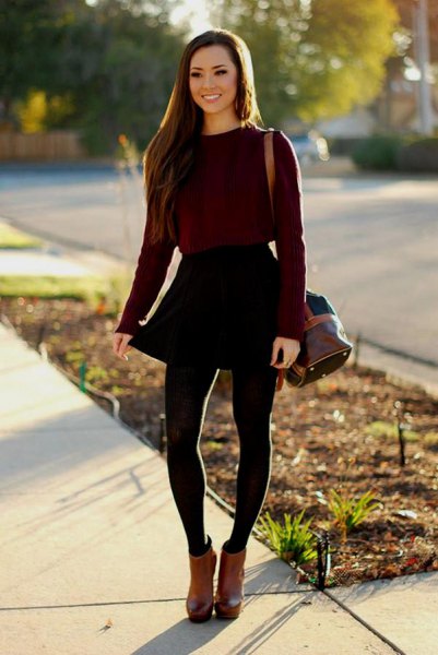 Black fitted sweater with a skater mini skirt and brown leather ankle boots