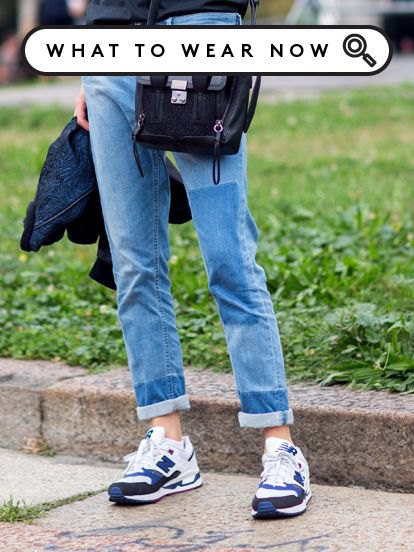 Cuffed slim fit jeans and white and blue denim and plastic running shoes