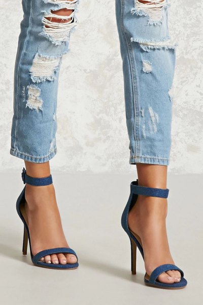 badly ripped slim fit jeans at the ankle and blue denim heels with ankle strap and open toe