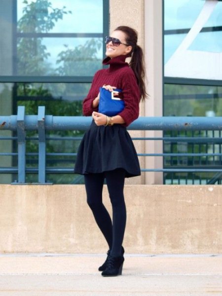Burgundy turtleneck sweater with rubbed collar and black mini skater skirt