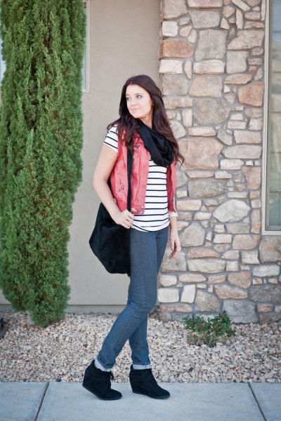 Black and white striped short sleeve t-shirt with beige vest and wedge boots