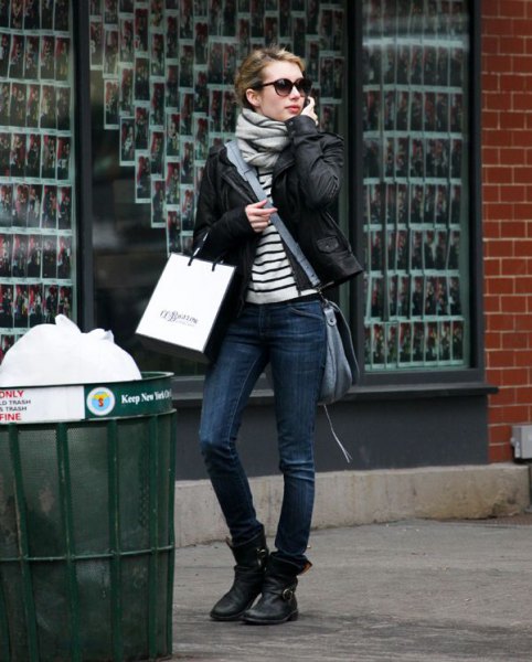 Black and white striped t-shirt with biker jacket and leather ankle
high motorcycle boots