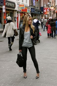Leather jacket with a gray scoop neck top and skinny jeans
