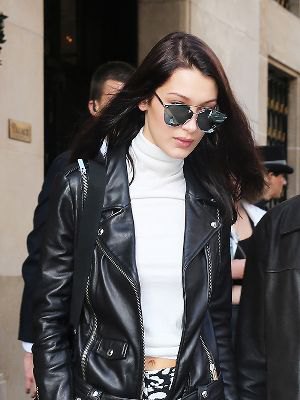 White short sweater with stand-up collar and black motorcycle jacket