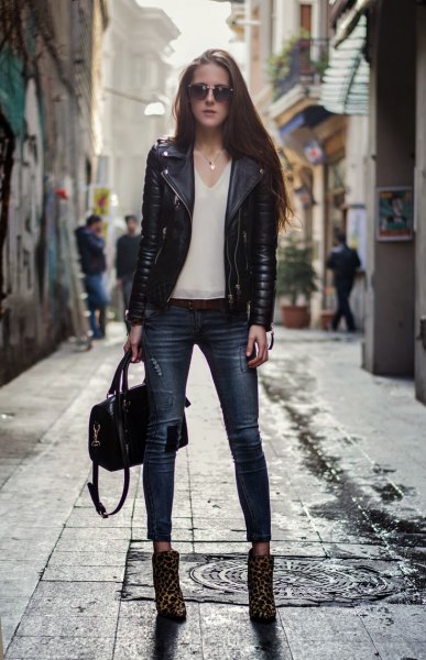 Black motorcycle jacket with white V-neck chiffon blouse and leopard print boots