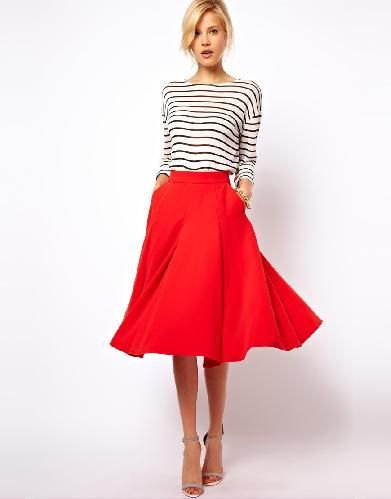 Black and white striped long sleeve t-shirt with red flared midi skirt