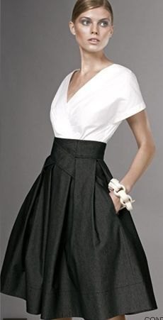 White V-neck wrap blouse and black high waisted flared midi skirt with pockets