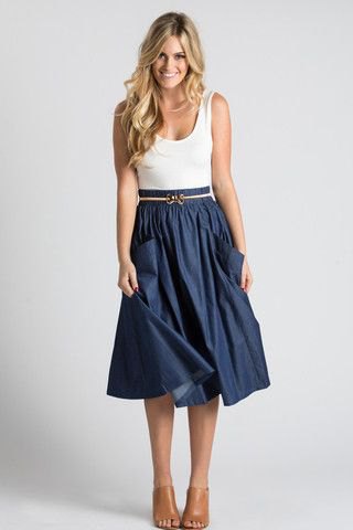 White scoop neck tank top and navy pleated midi skirt with belt and front pockets