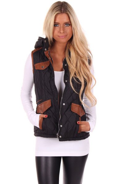Black hooded vest with white fitted long-sleeved t-shirt and leather leggings