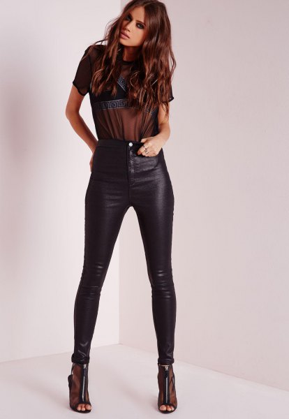 Black, semi-transparent, short-sleeved T-shirt with high-rise, waxed skinny jeans