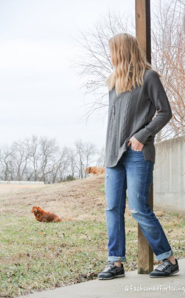 gray cable knit sweater with blue loose fitting cuffed jeans
