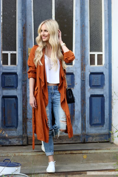Red long trench coat with ripped boyfriend jeans and white
sneakers