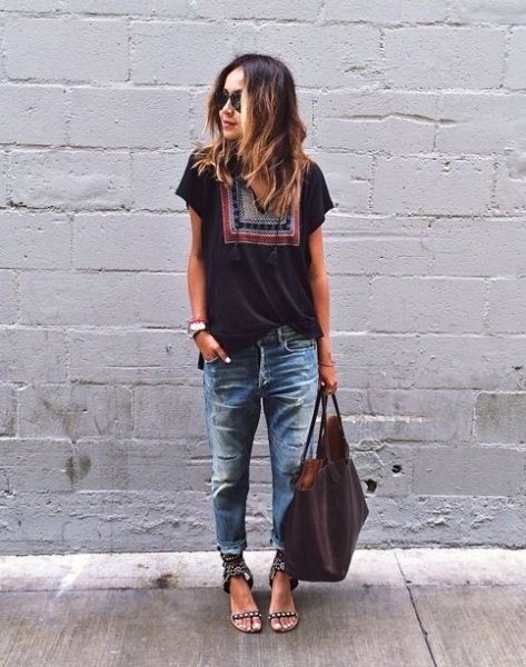 Black tribal print t-shirt and badly ripped and faded boyfriend
jeans