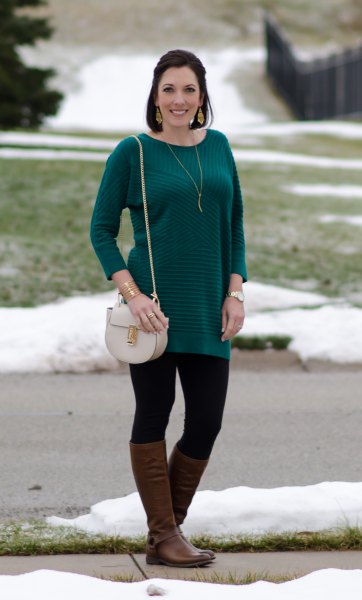 Long sleeve striped sweater with black leggings and brown leather boots