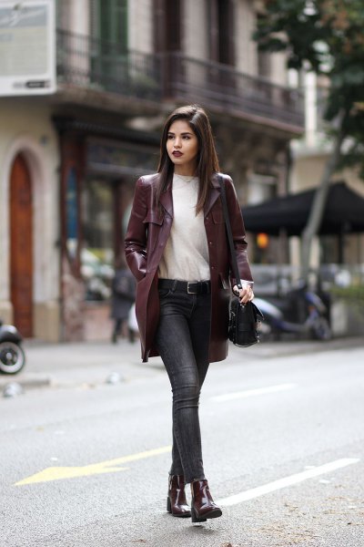 Burgundy long leather jacket with white sweater and jeans