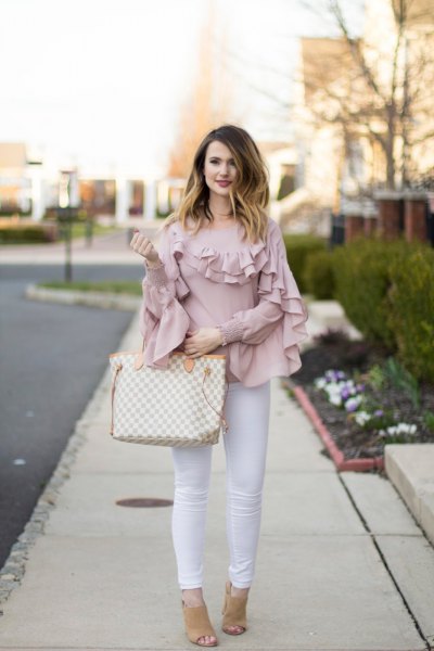 Pink shirt with ruffled sleeves and collar and white skinny jeans