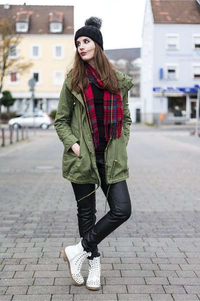 green long jacket with red and black checked scarf