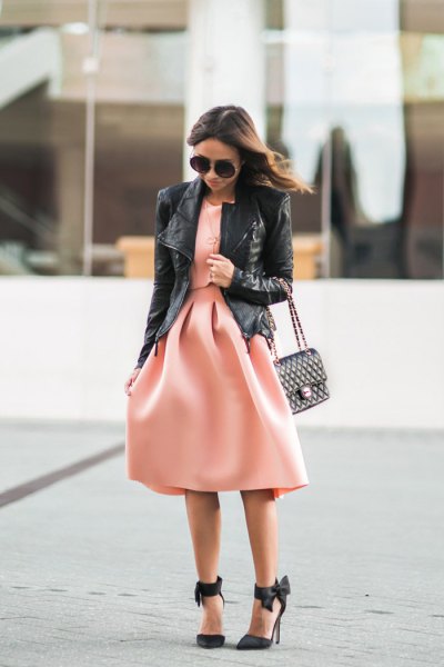 Black leather jacket with pink flared midi dress