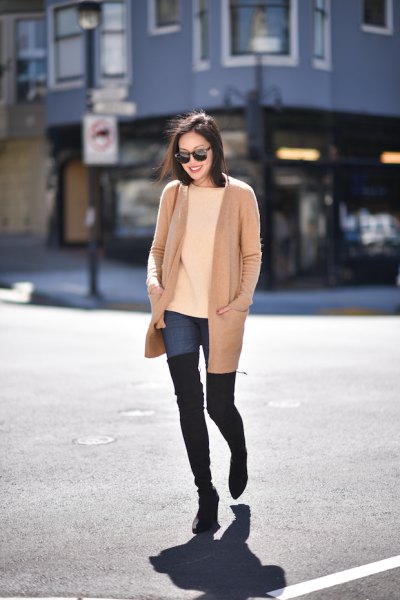Rouge pink long jacket with blue tall jeans and black thigh high boots