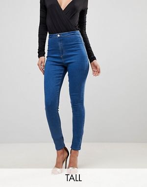 Black long sleeve bodycon plunging V-neck top and blue tall jeans
