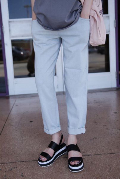 Gray loose-fitting blouse with light-colored cuffed jeans and slide
sandals