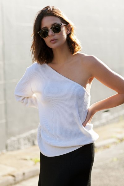 White ribbed one shoulder sweater with black mini skirt