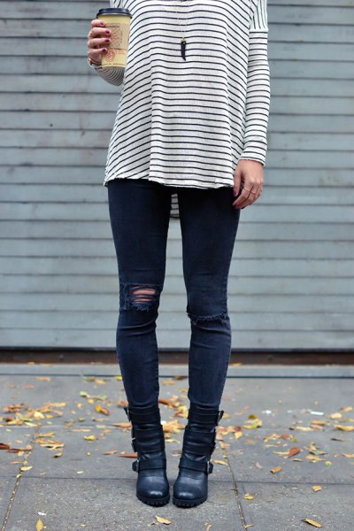 Black and white striped long sleeve t-shirt paired with dark blue ripped moto jeans