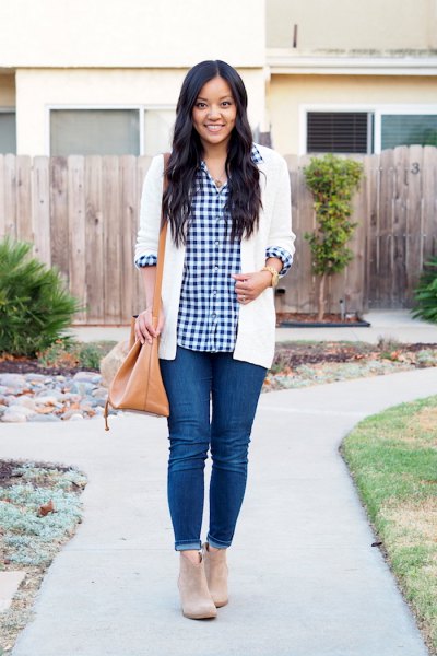 Black and white checked shirt with white cardigan and blue cuffed skinny jeans
