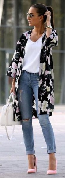 Black and white floral longline cardigan with three-quarter sleeves and blue cuffed jeans