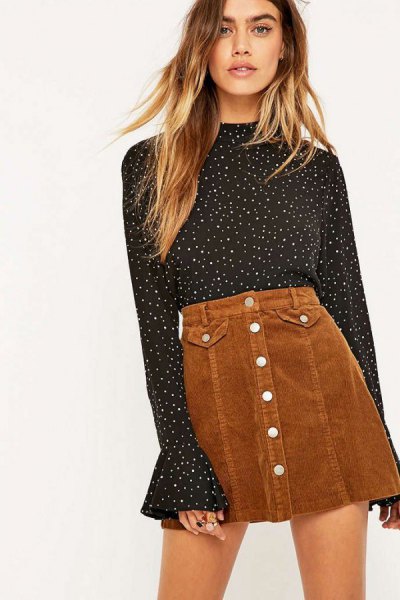Black and white polka dot blouse with bell sleeves and brown mini skirt
