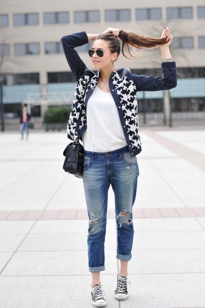 Black and white printed leather cardigan worn with really ripped jeans