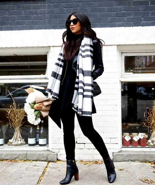 Black and white scarf with stand-up collar sweater and leather jacket