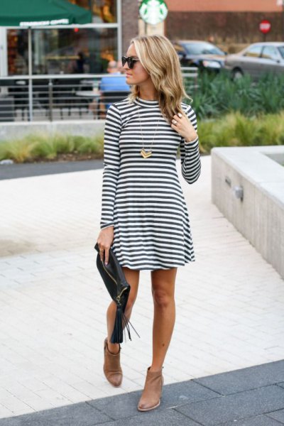 Black and white striped fit and flare high neck mini dress paired with brown leather ankle boots
