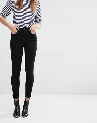 Black and white striped t-shirt paired with high-waisted skinny jeans