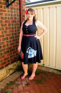 Black belted fit and flare midi dress with gray flip flops