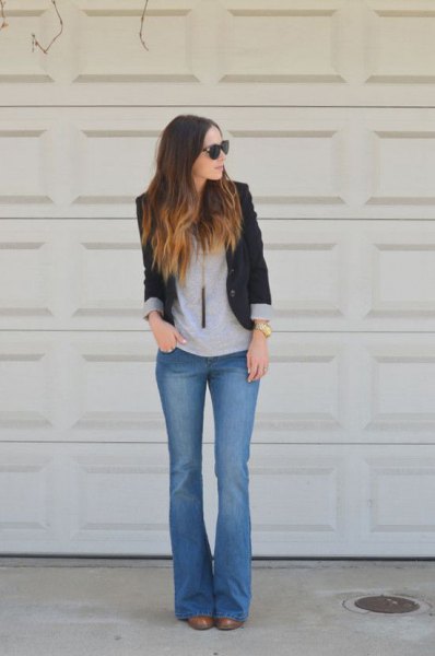 black blazer with gray t-shirt and blue flared jeans