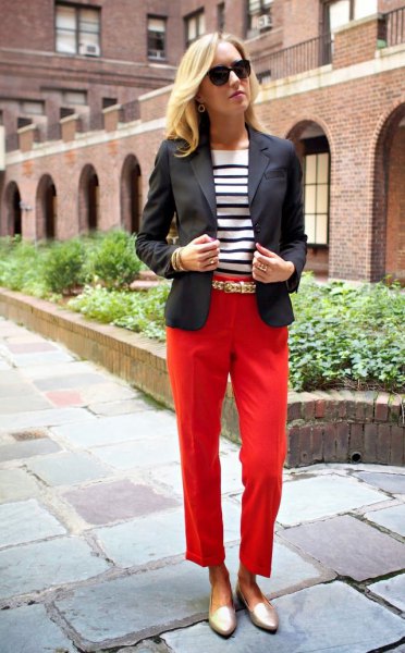 black blazer with red cropped trousers and golden slippers