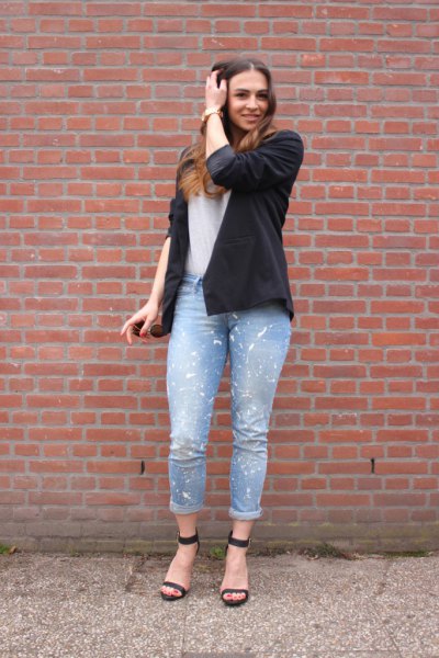 Black blazer with white t-shirt and light blue painted cuffed jeans
