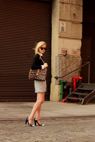 Black blouse with leopard print handbag and pink lace mini skirt