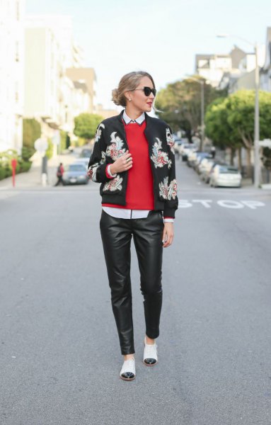 Black bomber jacket, red knit sweater and white cap-toe shoes